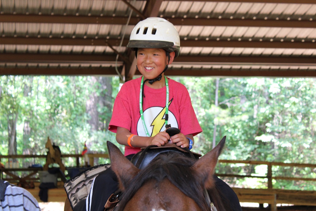 boy riding horse at camp wannaklot
