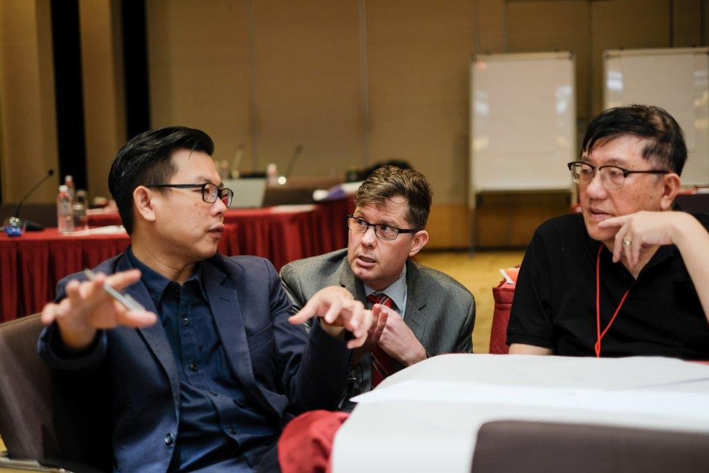 men discussing at table