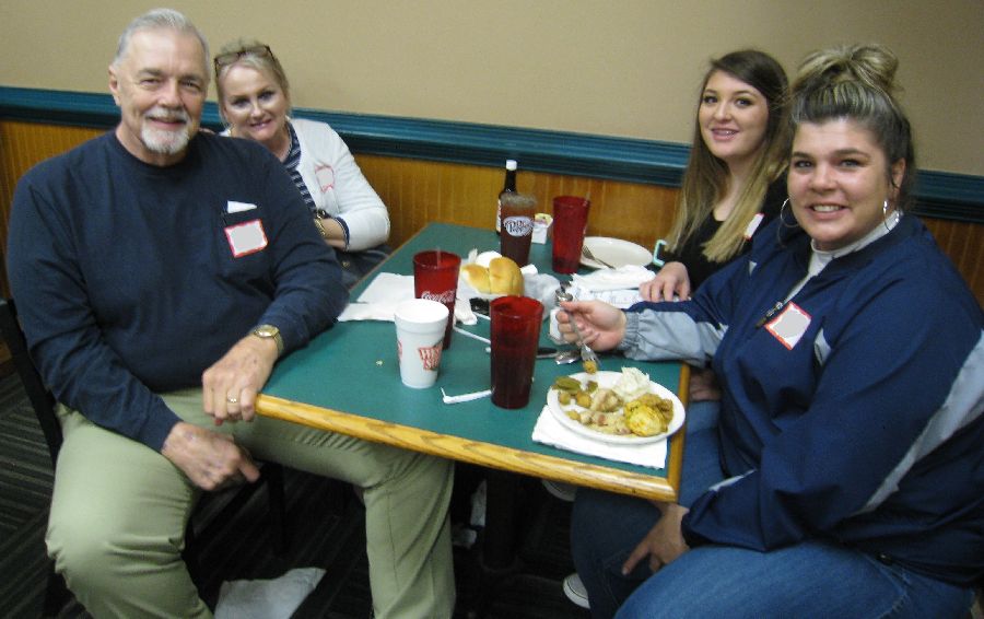 four people sitting to eat