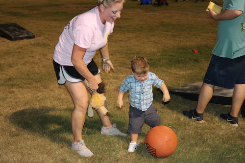 kid kicking a bola ball