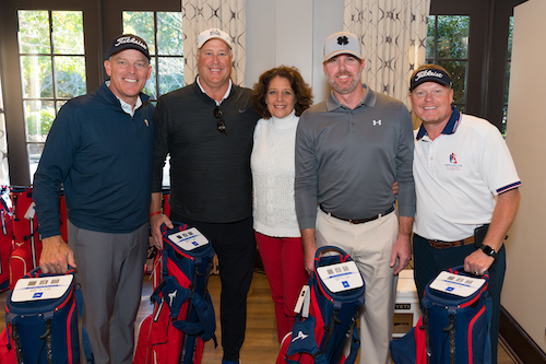 men lined up with their golf bags