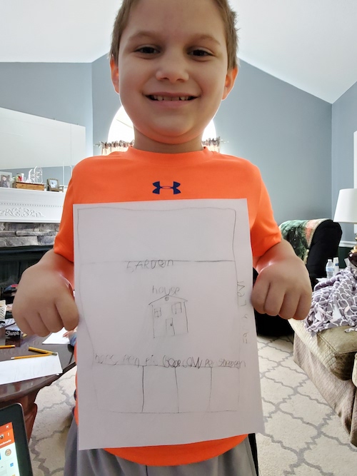 Boy holding camp certificate