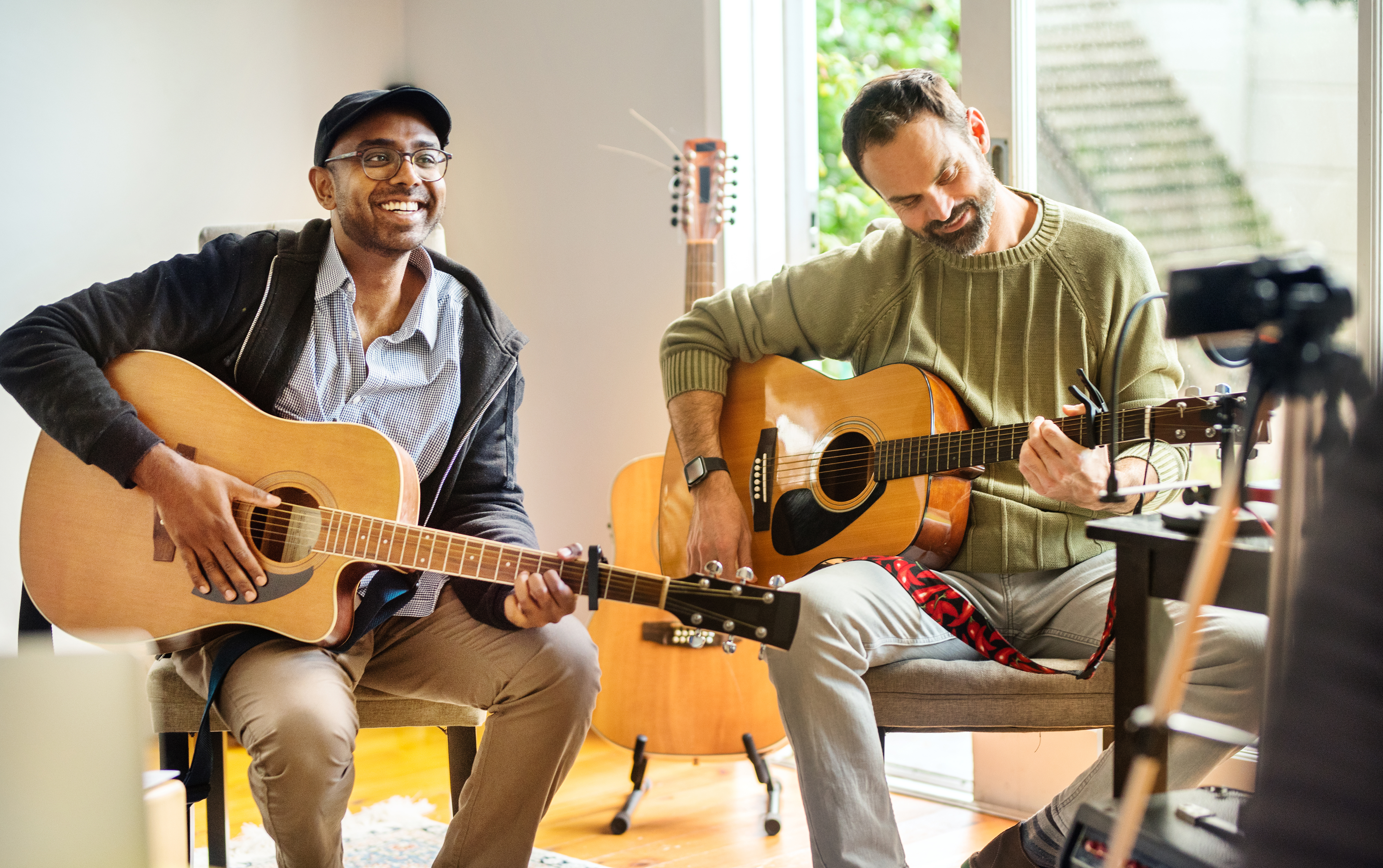 Two men playing guitar