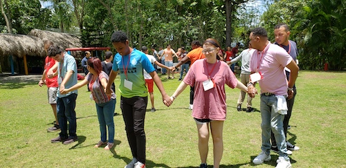 Group holding hands outside