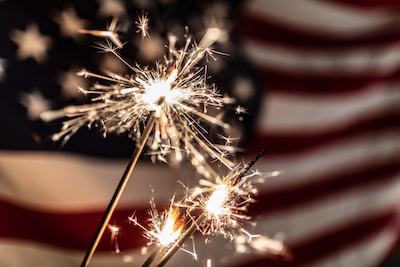 sparkler in front of the american flag