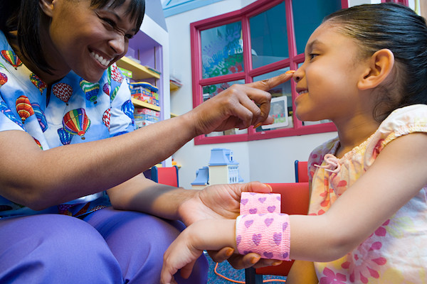 teacher tapping young girl on nose