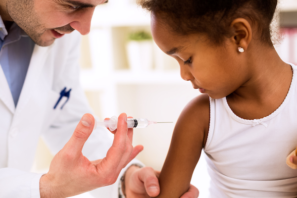 little girl getting a shot