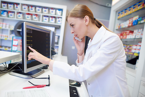 Pharmacist reviewing order on computer