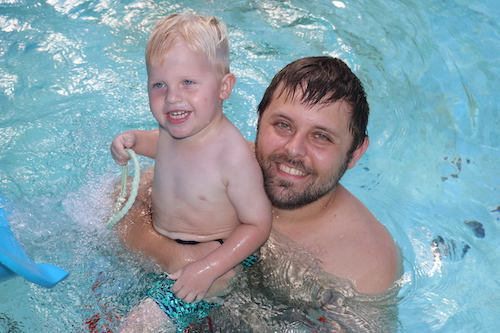 Father and son in pool