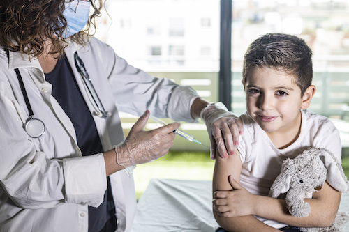 little boy receiving a shot