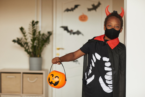 kid dressed as a skeleton for halloween